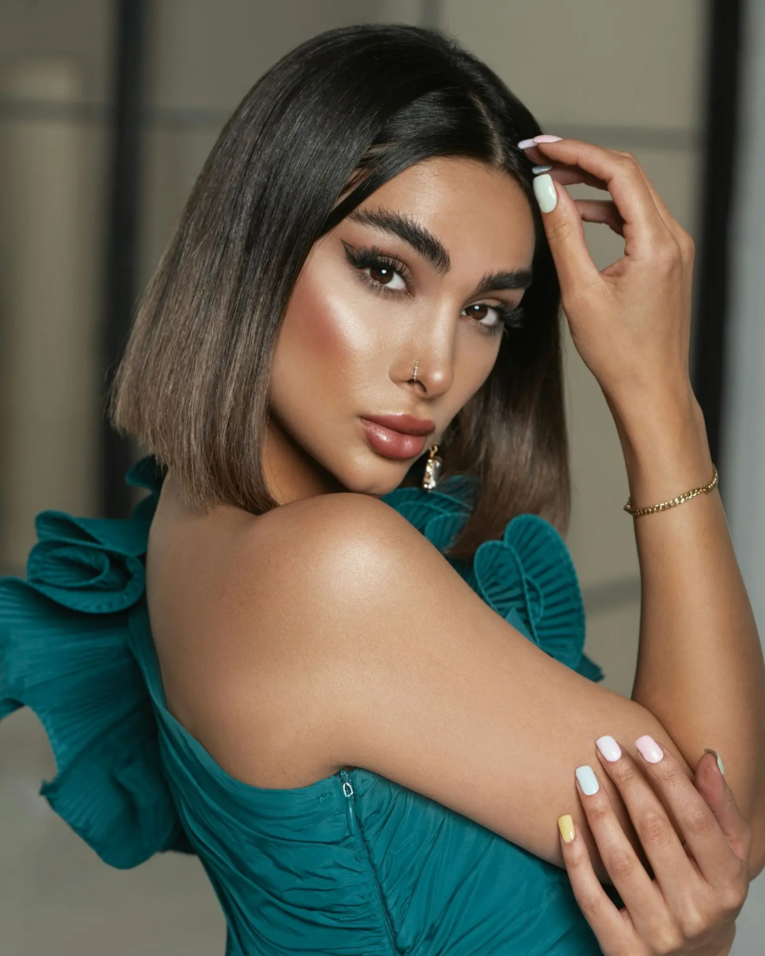 a woman in a green dress posing for a picture